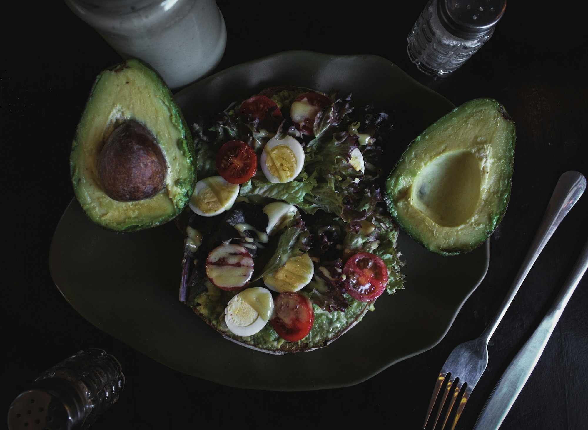 Avocado halves and hard-boiled eggs on a salad, a classic low-carb combination