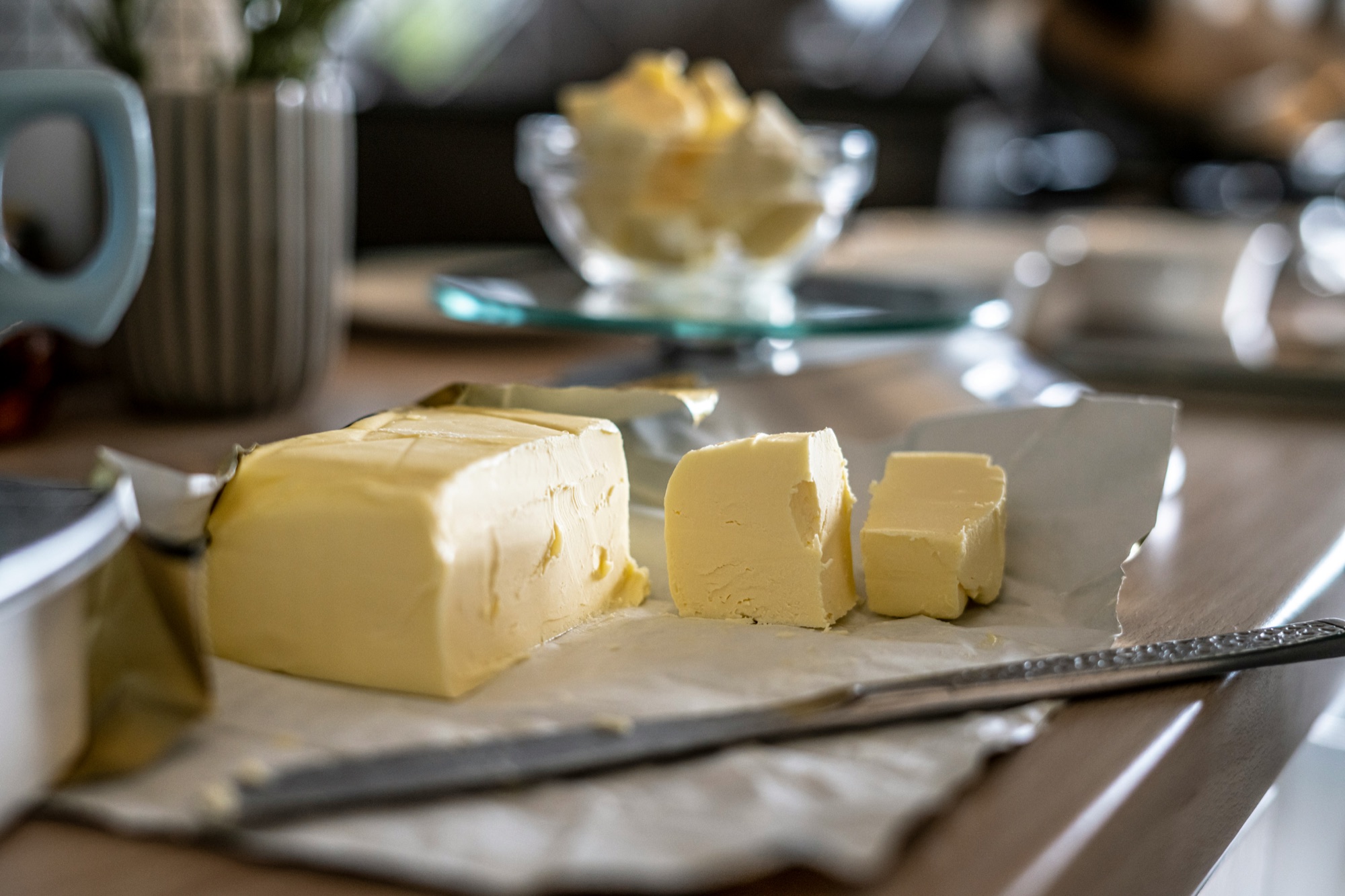 A block of butter being cut into pieces