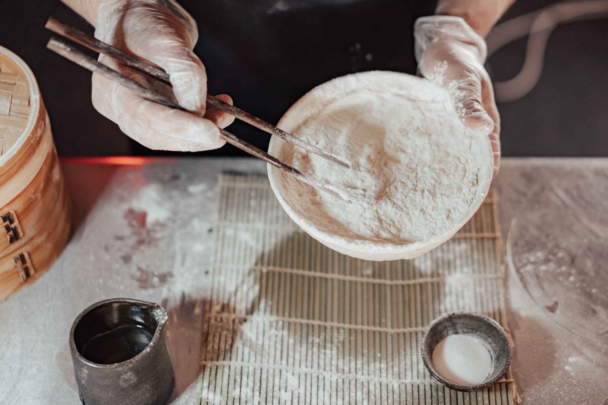 A bowl of fine starch powder being prepared with chopsticks